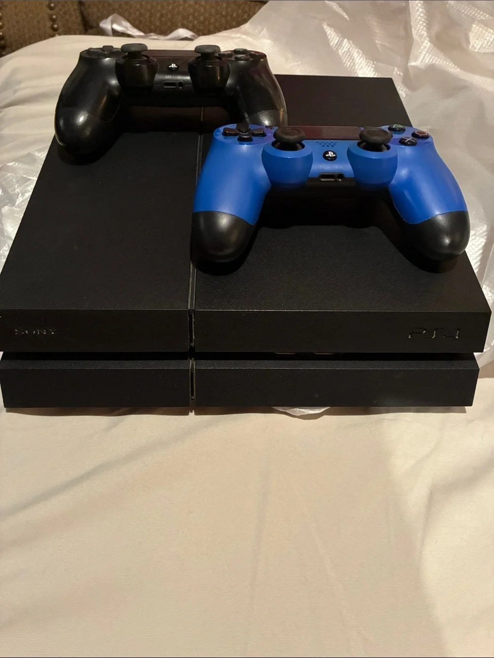 Sony PS4 Console with Black and Blue DualShock Controllers